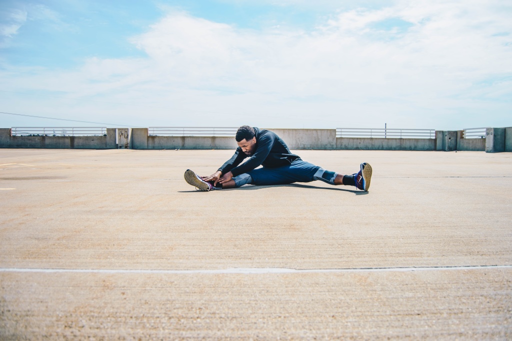 A man strikes a yoga pose on a rooftop in Los Angeles.